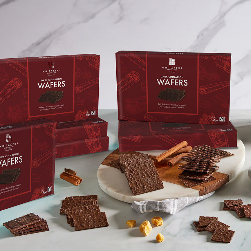 Dark chocolate Cinnamon wafers with red boxes on a marble surface