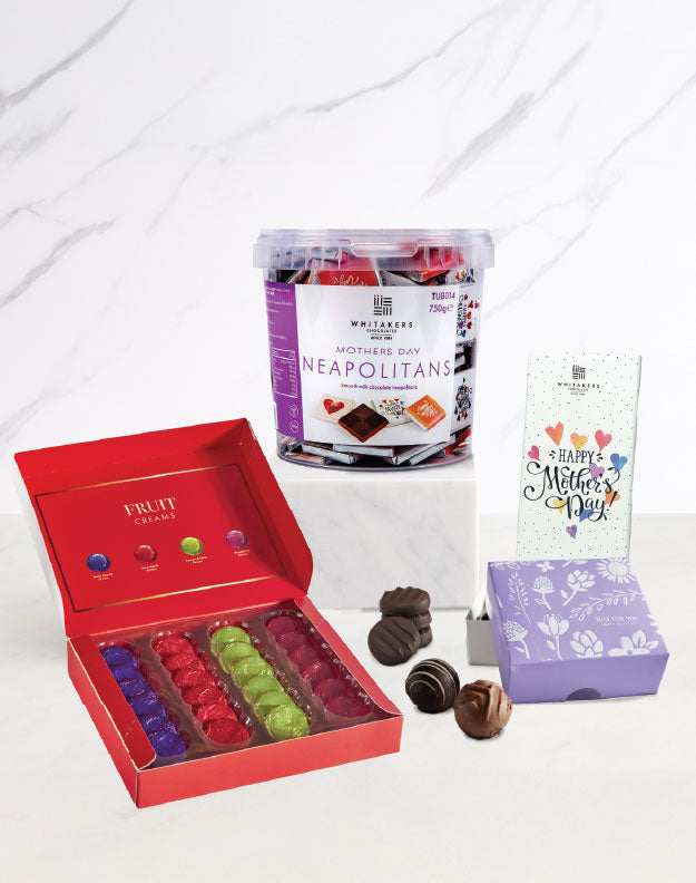 Assorted chocolates including a red box of truffles, a container of Neapolitans, and a small card on a white background.