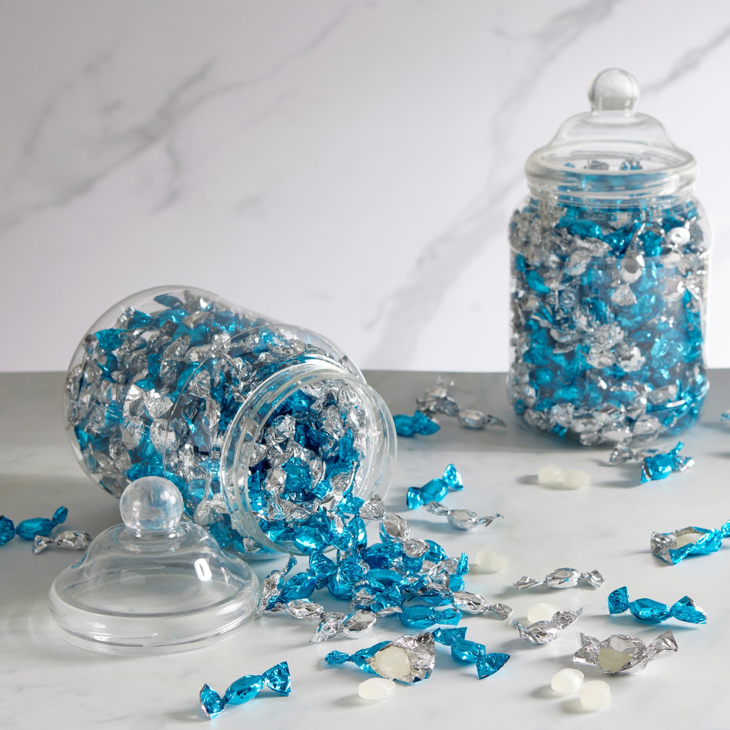 small, hard-boiled sweets, individually wrapped for freshness and convenience. These delightful peppermint-flavoured treats come in a vibrant mix of silver and blue wrappers