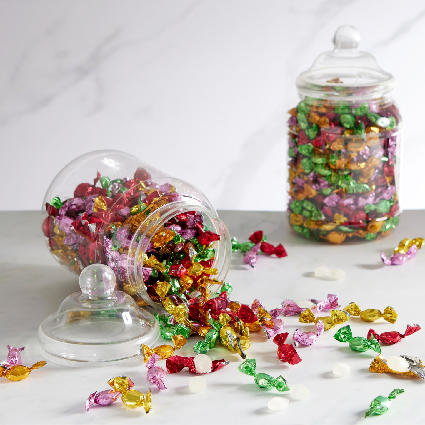 small, hard-boiled sweets, each bursting with the juicy essence of fruit flavours and individually wrapped in a rainbow of colourful wrapper