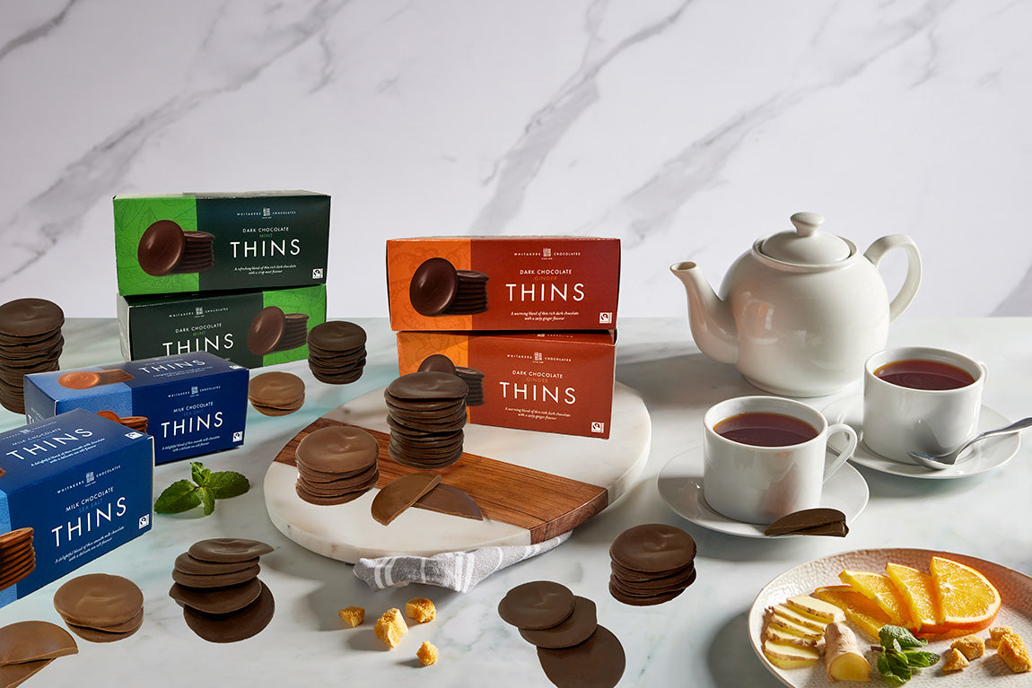 Afternoon tea setting with Whitakers new range of 150g gift boxes filled with milk and dark chocolate thins