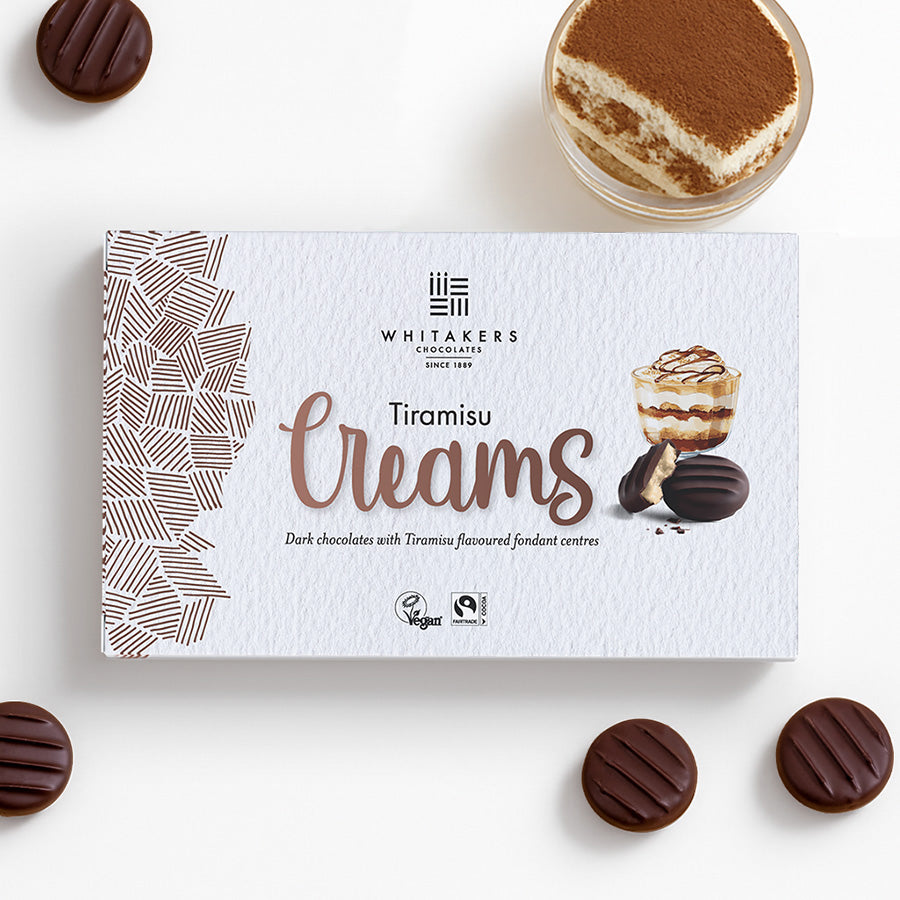 Whitaker's Tiramisu Creams packaging with chocolates and tiramisu on a white background