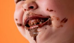 A Boy With Chocolate on His Teeth