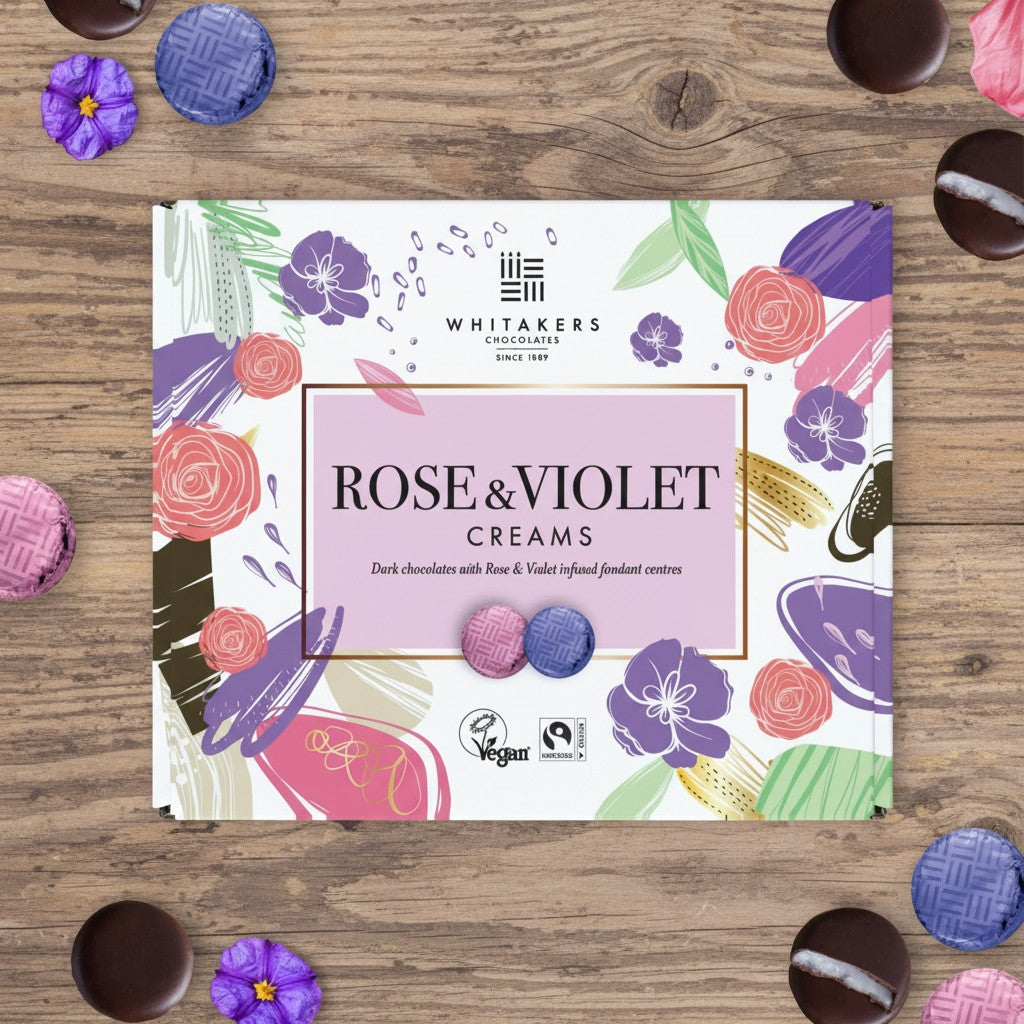 Whitakers Fairtrade dark chocolate rose & violet cream collection box on a wooden surface 