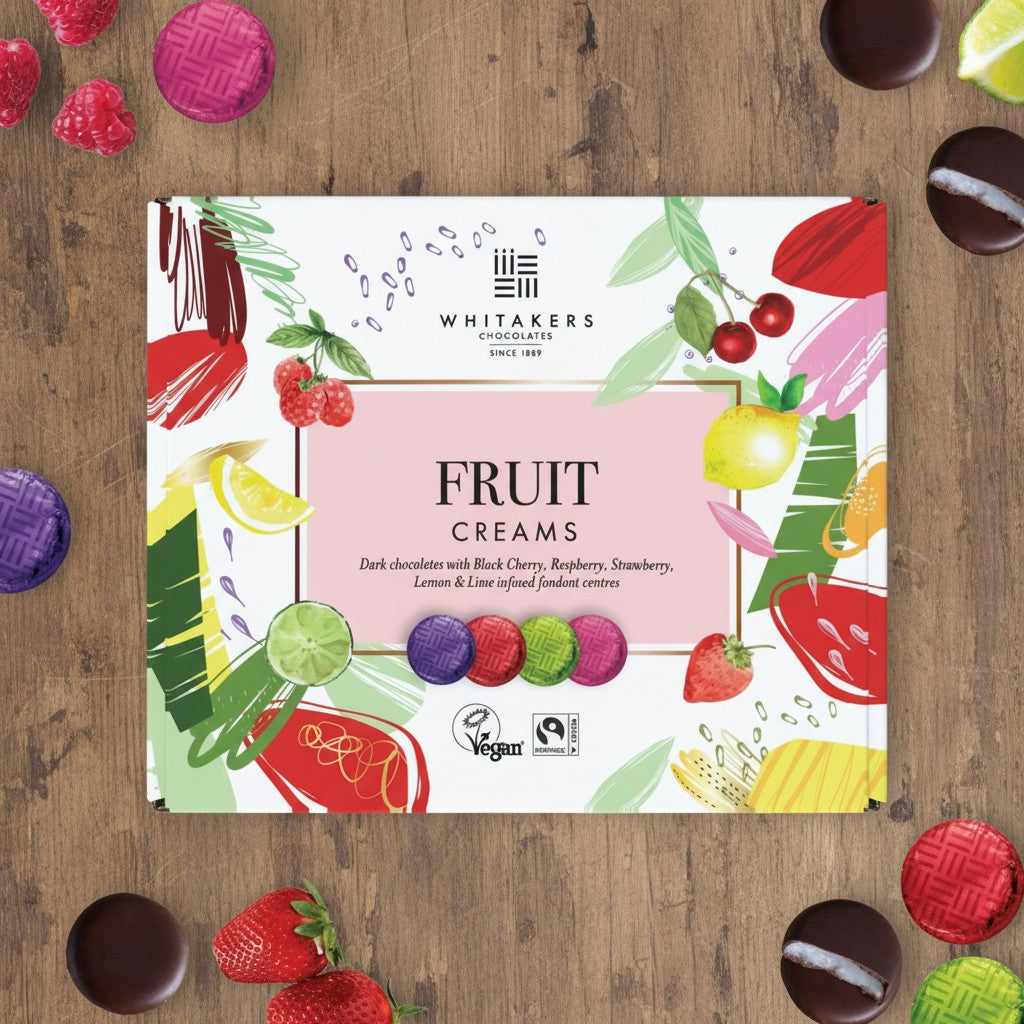 Whitakers Chocolates Fairtrade dark chocolate foiled fruit creams on a wooden background