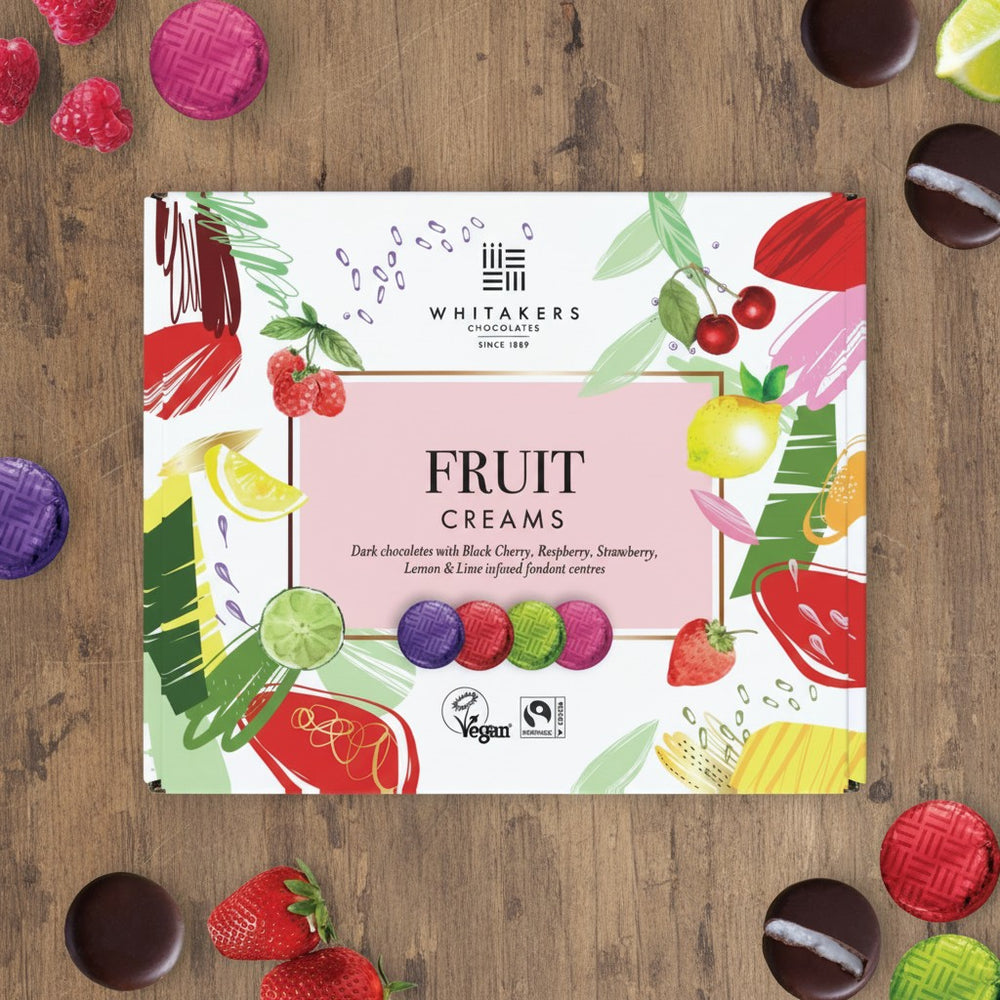 Whitakers Chocolates Fairtrade dark chocolate foiled fruit creams on a wooden background