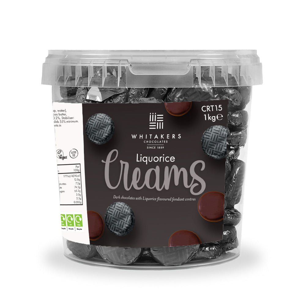 Clear plastic bulk tub of Dark chocolate black foiled Liquorice fondant creams by Whitakers Chocolates (1kg) on a white background