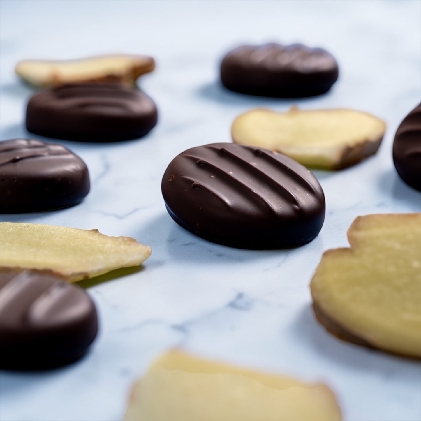 ginger slices and dark chocolate ginger creams on a marble countertop