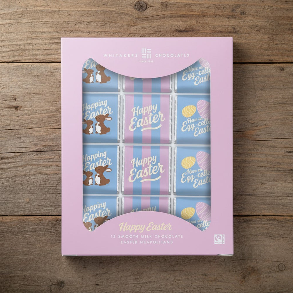 Easter-themed Fairtrade milk chocolate gift box with pink lid on a wooden surface