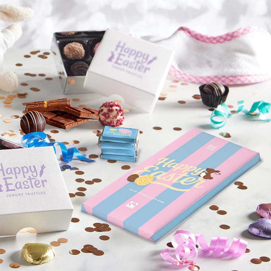 Easter-themed chocolate truffles and packaging on a white surface with confetti.