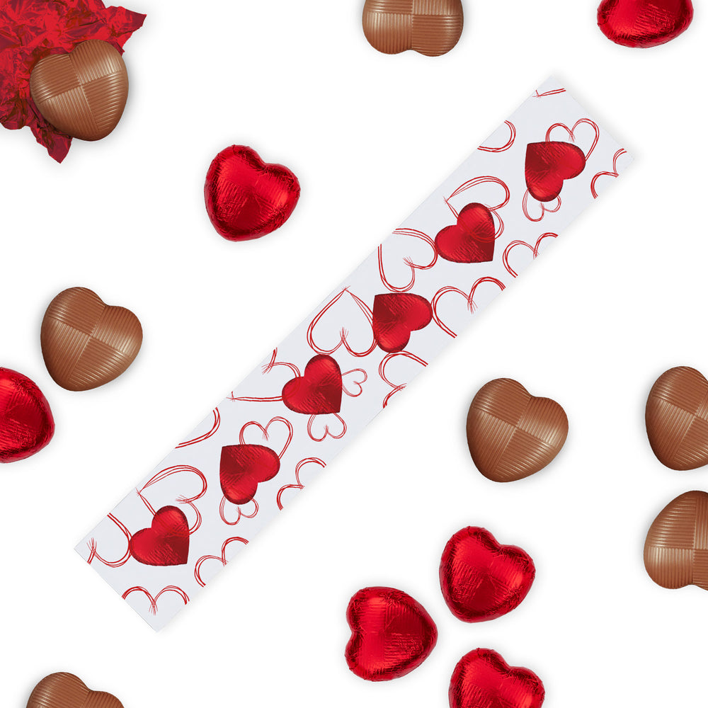 Love Hearts Chocolate Gift Box Stick, the perfect Valentine's Day treat to express your affection. This elegantly designed gift box is adorned with a red and white love heart pattern, featuring heart-shaped cutouts that playfully reveal the Luxury red-foiled milk chocolate hearts within. Each box contains six exquisite milk chocolate hearts