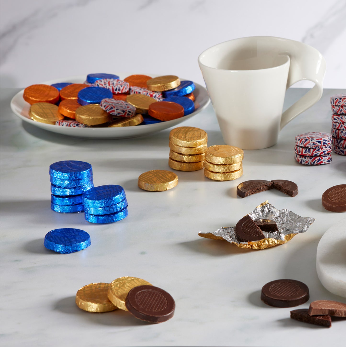assorted milk and dark chocolate crisps in a variety of foil colours