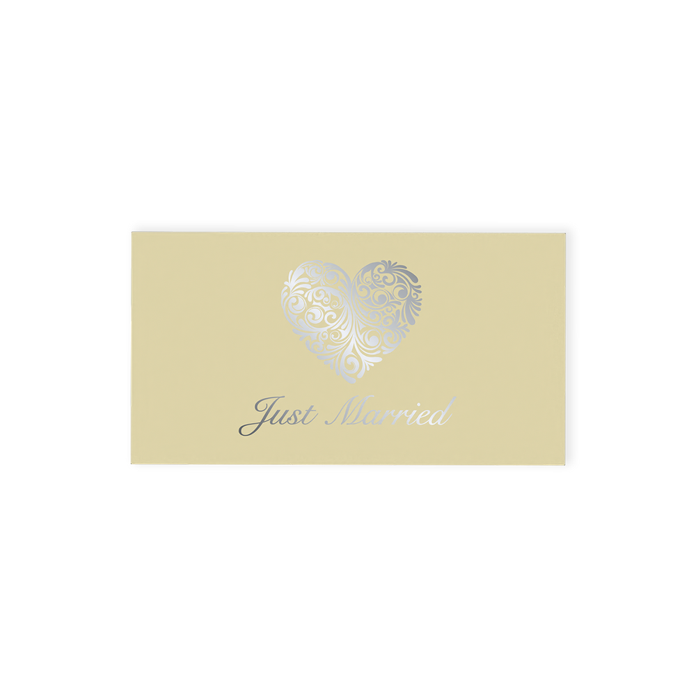 "Just Married" Chocolate Gift Box, an exquisite offering that pairs elegance with indulgence.  This cream-coloured gift box is beautifully adorned with an ornate silver heart and stylish "Just Married" font on the top, making it a standout addition to any wedding celebration.  Inside, discover two delicious hand-finished truffles, one milk and one white chocolate