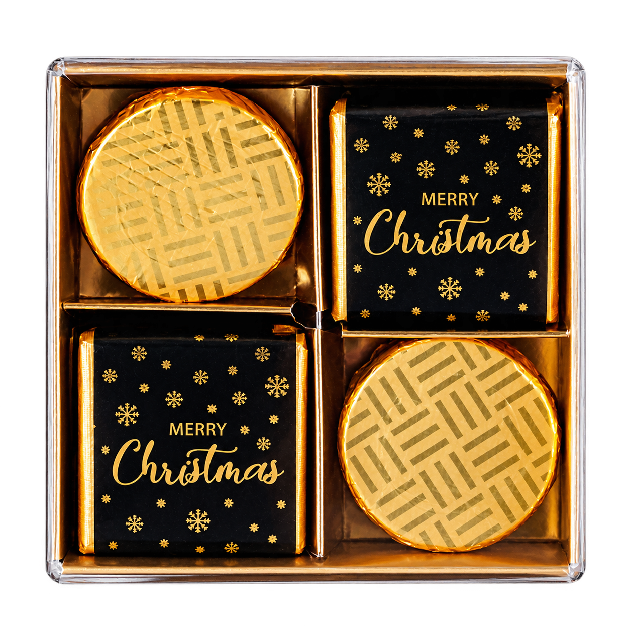 A boxed set of four holiday chocolates in a clear square gift box. Two chocolates are wrapped in shiny gold foil, and two are wrapped in black paper with gold 'MERRY Christmas' text and snowflake motifs.