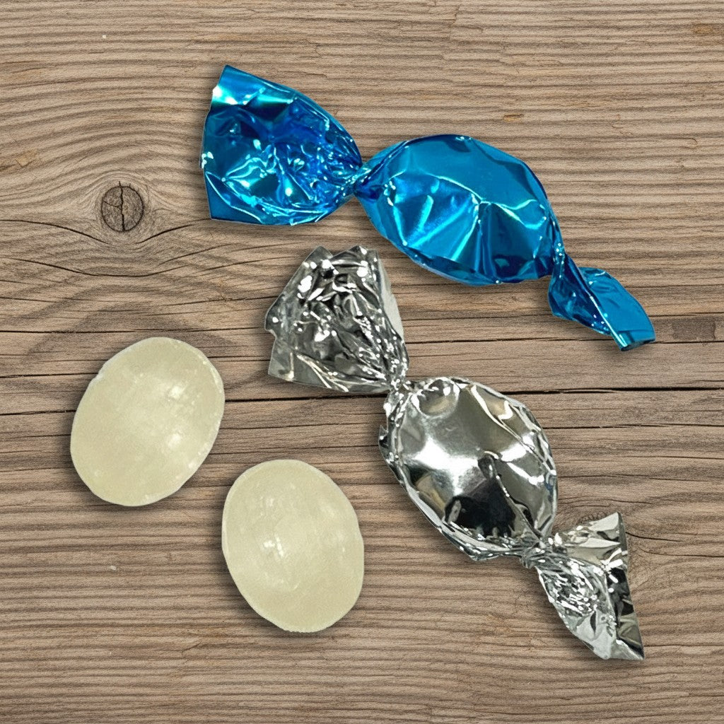 Mint Candies with blue and silver wrappers on a wooden surface