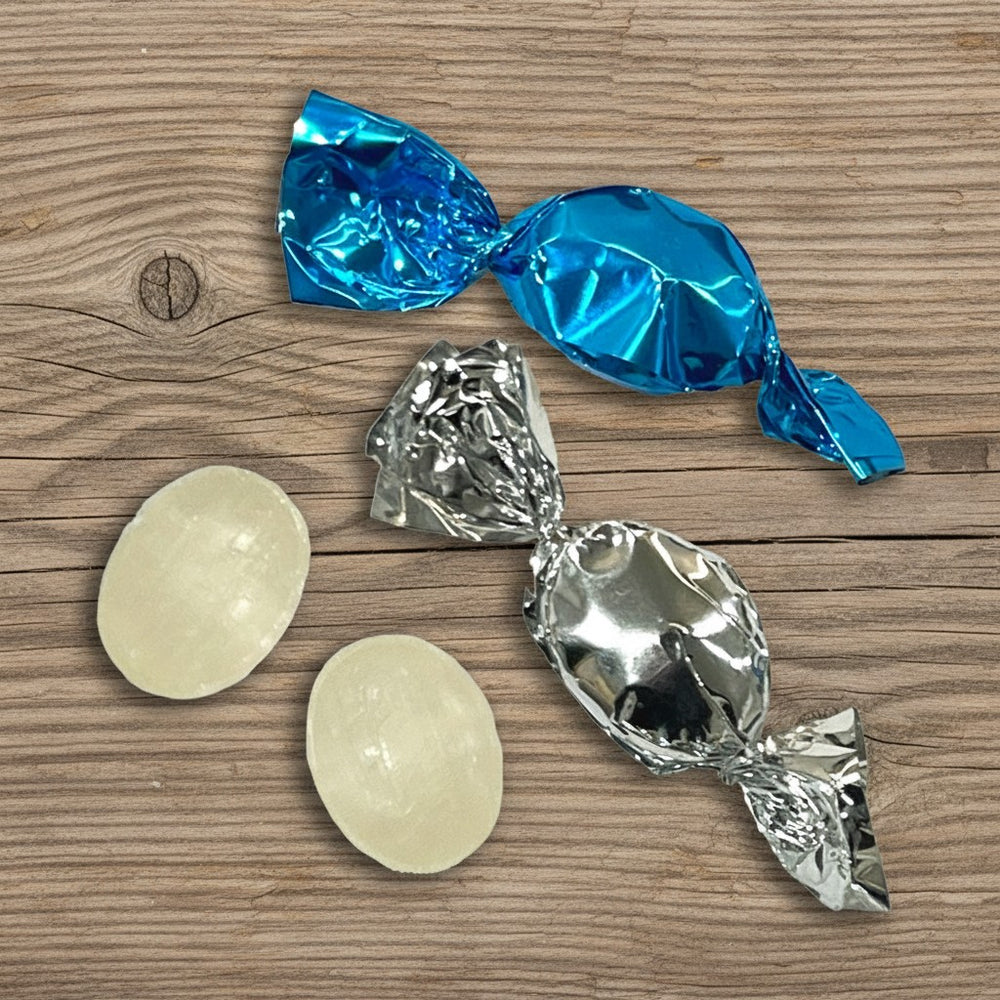 Mint Candies with blue and silver wrappers on a wooden surface