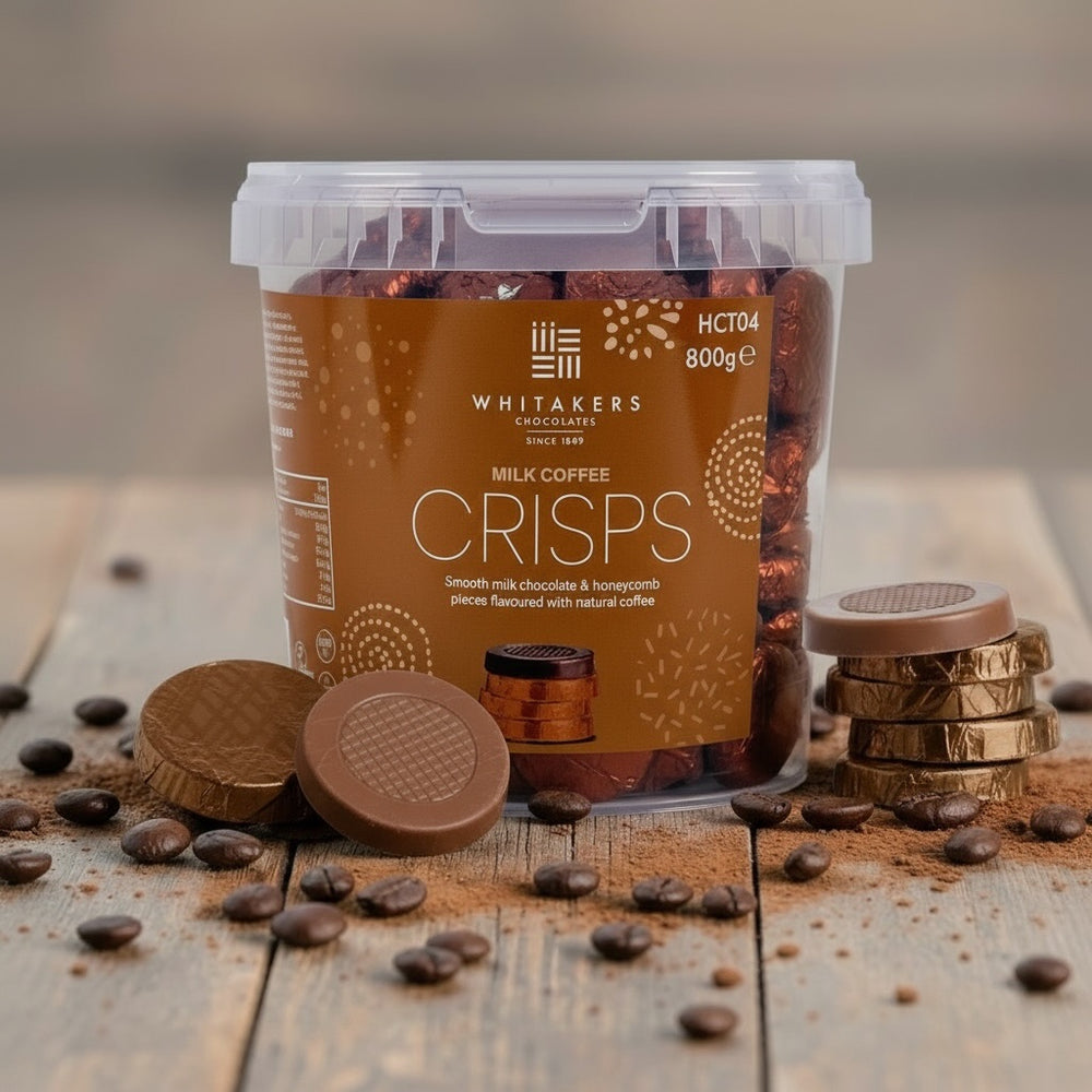 Container of Whitakers Milk Coffee Crisps on a wooden surface with coffee beans.