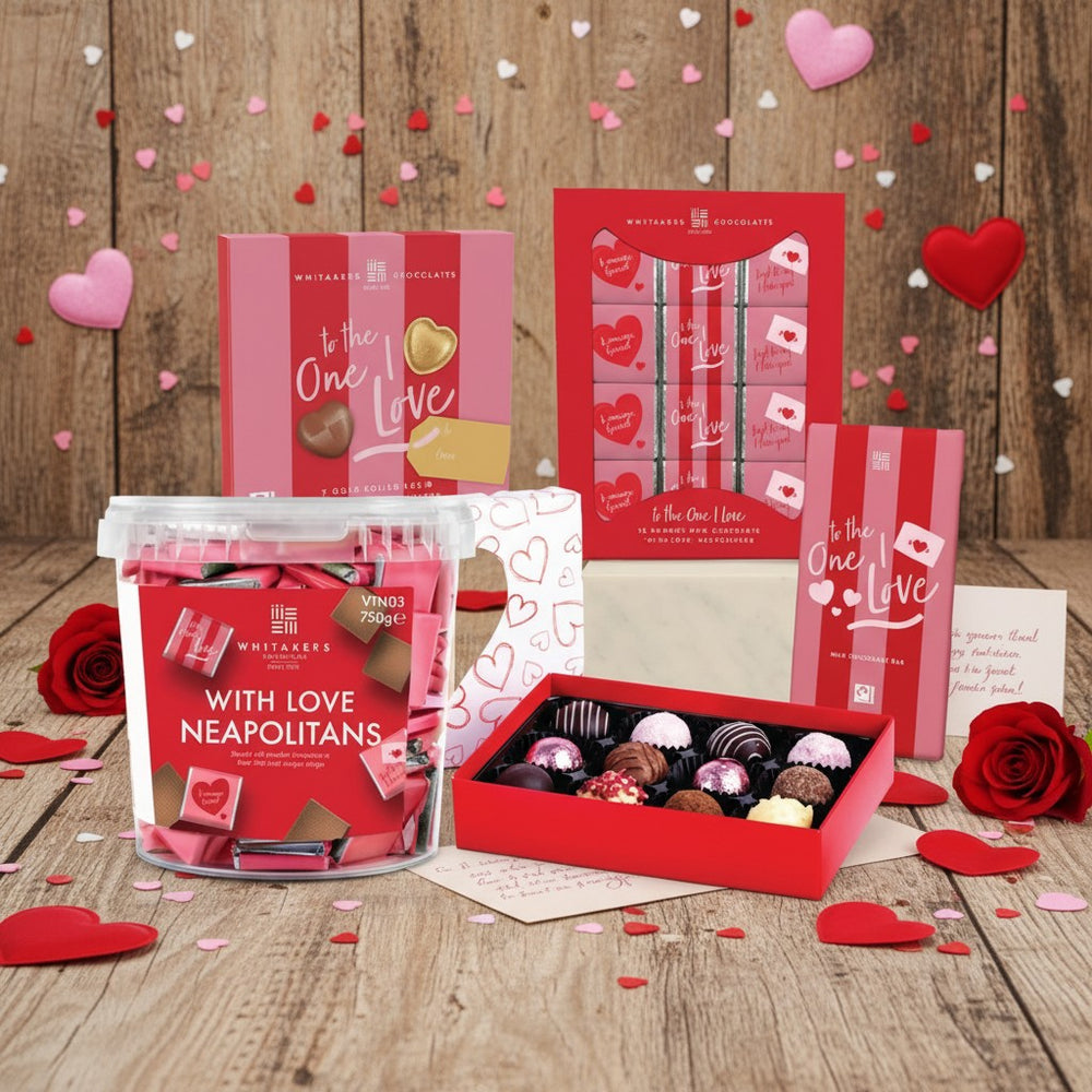 Valentine's Day chocolate gift set with pink and red packaging on a wooden surface.