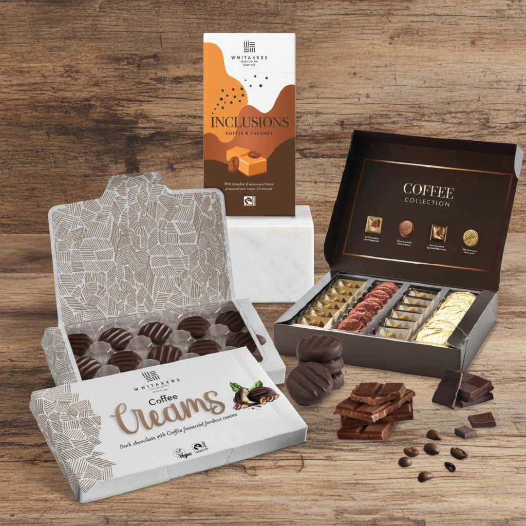 Whitakers Chocolates Fairtrade Coffee Companion pack, including milk coffee and caramel inclusion bar, milk and dark chocolate coffee collection, dark chocolate coffee fondant creams on a wooden background