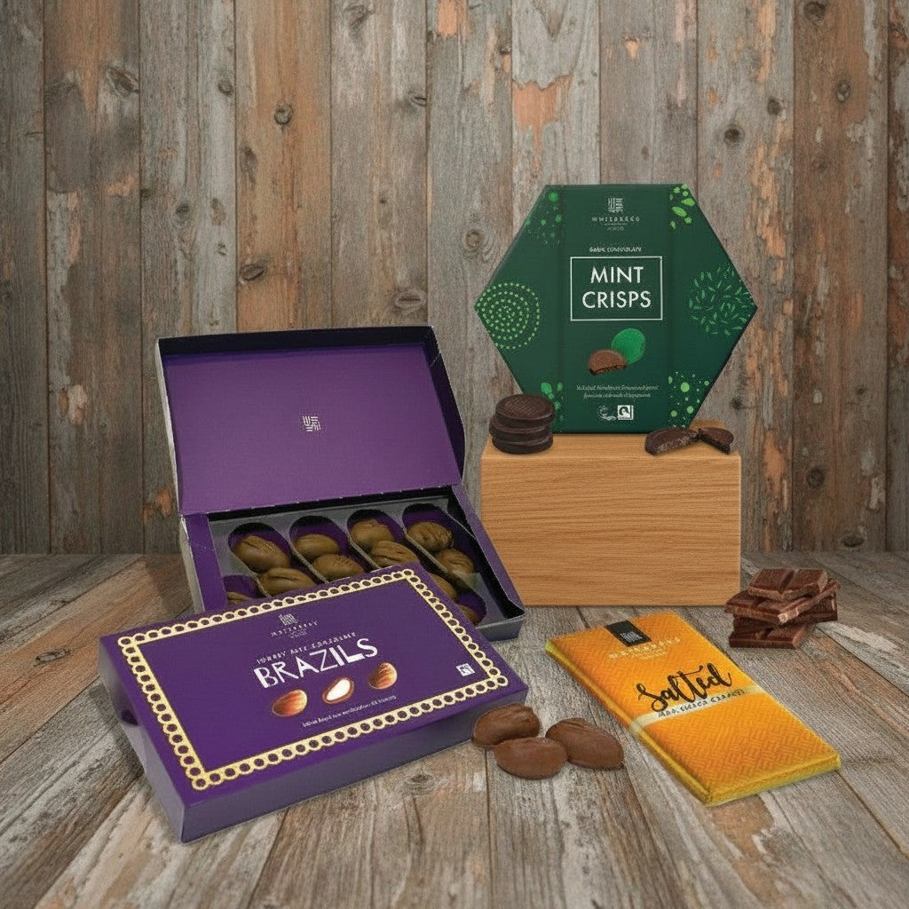Assorted chocolate products including 'Brazils' and 'Mint Crisps' on a wooden surface.